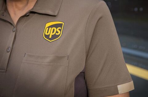 Closeup of the UPS logo embroidered on a uniform shirt.